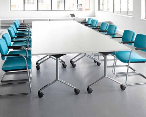 Foldable meeting room table with colourful chairs