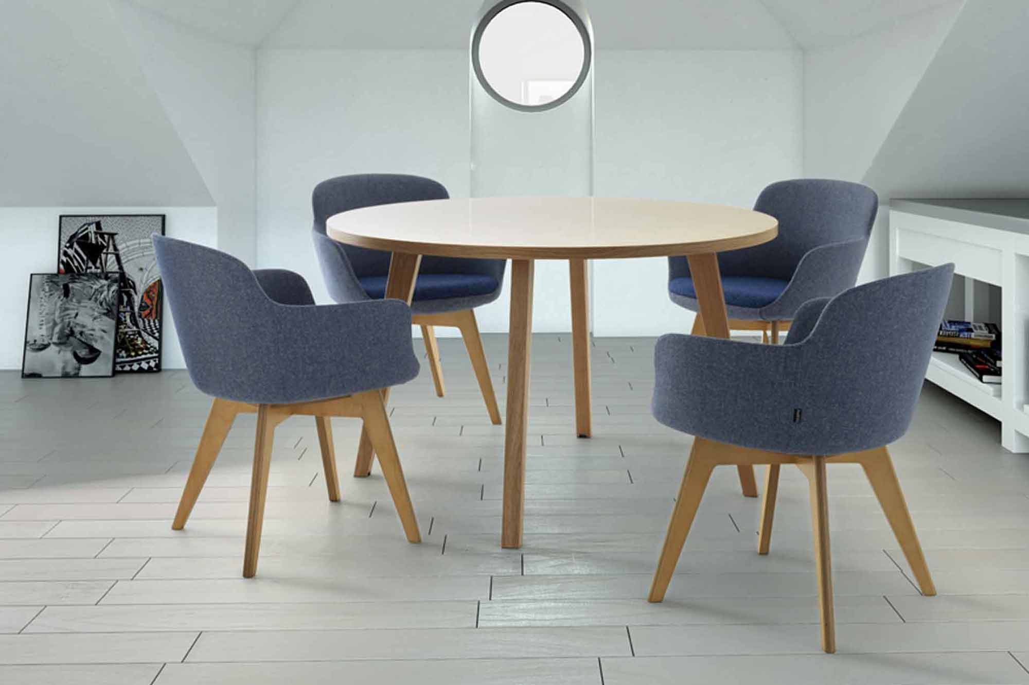 Casual meeting space in office with four chairs and wooden table