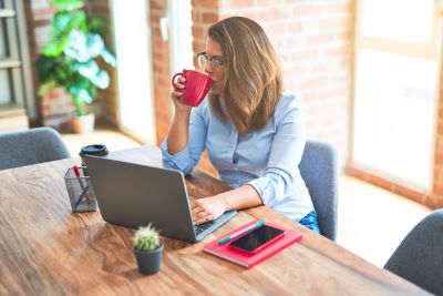 employee hot desking drinking coffee