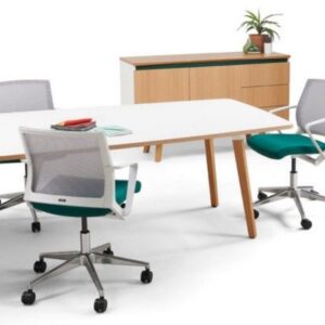 Lismark meeting room setup with a white rectangular table, multiple light grey mesh chairs with teal seats, and a light wooden storage credenza with green accents and a plant.