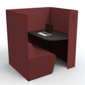 Dark red fabric office privacy booth with a black desk and a laptop inside.