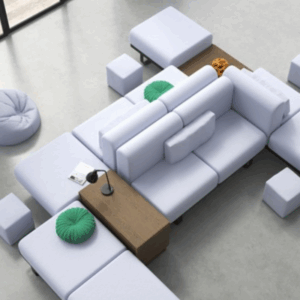 Overhead view of a modular white sofa arrangement with green accent cushions wooden side tables and light blue bean bags.