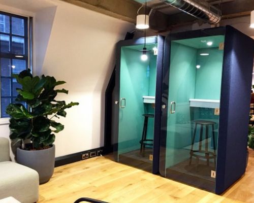 How do phone booths improve productivity in busy offices